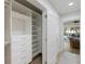 Organized walk-in closet with custom shelving, drawers, and ample storage space at 842 Nokomis S Ave, Venice, FL 34285