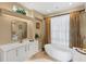 Spa-like bathroom with freestanding tub and updated vanity at 857 Blue Crane Dr, Venice, FL 34285