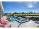 Resort-style pool and spa with patio furniture, offering lake views at 857 Blue Crane Dr, Venice, FL 34285