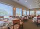 Bright dining room with tables and chairs near large windows at 995 Chickadee Dr, Venice, FL 34285