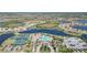 Aerial view of luxury community with resort-style amenities including pool, tennis courts, and lake at 20230 Granlago Dr, Venice, FL 34293