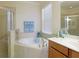 Bathroom boasts a large soaking tub and double vanity at 20230 Granlago Dr, Venice, FL 34293