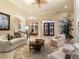 Elegant living room with ample seating, a coffee table, and decorative rug at 11 Carisa Royale Ct, Englewood, FL 34223