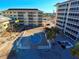 Aerial view showing condo building, pool, and surrounding area at 1200 Tarpon Center Dr # 204, Venice, FL 34285