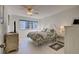 Bright bedroom with a floral comforter and tile floors at 1200 Tarpon Center Dr # 204, Venice, FL 34285