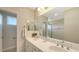 Double vanity bathroom with a large mirror and shower at 12664 Sagewood Dr, Venice, FL 34293