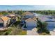 Two-story house with gray siding, tile roof and a two-car garage, overlooking a lake at 12664 Sagewood Dr, Venice, FL 34293