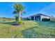 Large backyard with lake view and screened lanai at 13097 Rinella St, Venice, FL 34293