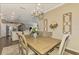 Spacious dining area with a rustic table and views into the kitchen at 13097 Rinella St, Venice, FL 34293