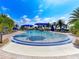 Relaxing resort-style pool with blue umbrellas and lounge chairs at 13097 Rinella St, Venice, FL 34293