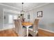 Bright dining area with a wooden table, comfortable seating, and a view of the kitchen at 1333 Whispering Ln, Venice, FL 34285