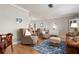 Bright living room with hardwood floors, comfy seating, and a stylish rug at 1333 Whispering Ln, Venice, FL 34285