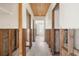 Hallway under renovation, showing exposed studs and flooring at 1360 Aqua View Ln, Englewood, FL 34223