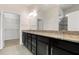 Elegant bathroom with dark wood cabinets and granite countertop at 13825 Karina St, Venice, FL 34293