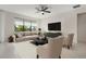 Living room with beige sofas and a large flat screen TV at 13825 Karina St, Venice, FL 34293