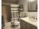 Clean bathroom with a tub, shower, and gray vanity with marble top at 145 Jose Gaspar Dr # 145, Englewood, FL 34223