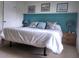 Main bedroom with a king-size bed and teal plank accent wall at 145 Jose Gaspar Dr # 145, Englewood, FL 34223