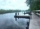 Multiple wooden boat docks situated along a calm waterway, providing ample space for watercraft at 145 Jose Gaspar Dr # 145, Englewood, FL 34223