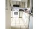 Cozy kitchen featuring white cabinetry, granite countertops, and modern appliances at 145 Jose Gaspar Dr # 145, Englewood, FL 34223