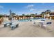 Community pool with tables and chairs at 1708 Bonitas Cir # 1726A, Venice, FL 34293