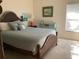 Comfortable bedroom with a light blue bedding set and a wooden frame bed at 1809 Curry Ave # 61, Nokomis, FL 34275