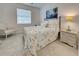 Guest bedroom with a coastal-themed bedspread and seating at 19070 Cabernet Ct, Venice, FL 34293