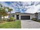 Single-story home with gray garage and landscaped lawn at 19070 Cabernet Ct, Venice, FL 34293