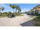 Relaxing poolside patio with tables and chairs at 19874 Benissimo Dr, Venice, FL 34293