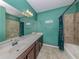 Teal bathroom with a single vanity and a tub at 20389 Lagente Cir, Venice, FL 34293