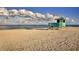 Peaceful beach scene with a lifeguard stand under a cloudy sky at 20389 Lagente Cir, Venice, FL 34293