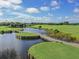 Aerial view of a scenic golf course with water features at 20389 Lagente Cir, Venice, FL 34293