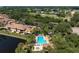 Aerial view showing community pool and canal at 2078 Oakridge Cir # A7, Venice, FL 34293