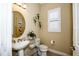 Powder room with pedestal sink and decorative accents at 23739 Waverly Cir, Venice, FL 34293