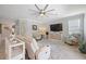 Relaxing living room with reclining sofas, a large TV, and plenty of natural light at 24036 Spartina Dr, Venice, FL 34293