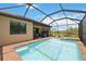 Relaxing screened pool and spa with view of backyard at 24036 Spartina Dr, Venice, FL 34293