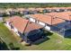 Aerial view of homes with tile roofs near lake at 24176 Spartina Dr, Venice, FL 34293