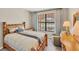 Comfortable bedroom with wood furniture and large window at 24176 Spartina Dr, Venice, FL 34293