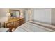 Bedroom with wood dresser and large bed at 24176 Spartina Dr, Venice, FL 34293