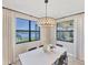 Dining room with lake views and modern light fixture at 24176 Spartina Dr, Venice, FL 34293