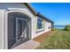 Exterior view of home with screened porch, lake view, and landscaped yard at 24176 Spartina Dr, Venice, FL 34293
