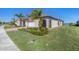 Single-Gathering home exterior with a white garage door and manicured lawn at 24176 Spartina Dr, Venice, FL 34293