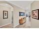 Elegant hallway with wood console table and artwork at 24176 Spartina Dr, Venice, FL 34293