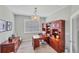 Home office with large desk and built-in shelving at 24176 Spartina Dr, Venice, FL 34293