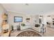 Bright and airy living room with a sectional sofa and large TV at 24176 Spartina Dr, Venice, FL 34293