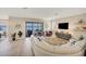 Open concept living room with curved sofa and lake view at 24176 Spartina Dr, Venice, FL 34293