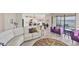 Open concept living room with curved sofa and kitchen views at 24176 Spartina Dr, Venice, FL 34293