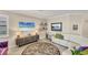 Living room features a sectional sofa, large TV and stylish decor at 24176 Spartina Dr, Venice, FL 34293