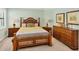Main bedroom with king-size bed and dresser at 24176 Spartina Dr, Venice, FL 34293