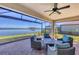 Enjoy lake views from this comfortable screened patio with seating at 24176 Spartina Dr, Venice, FL 34293