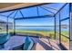 Relaxing screened patio overlooking a lake with seating area at 24176 Spartina Dr, Venice, FL 34293